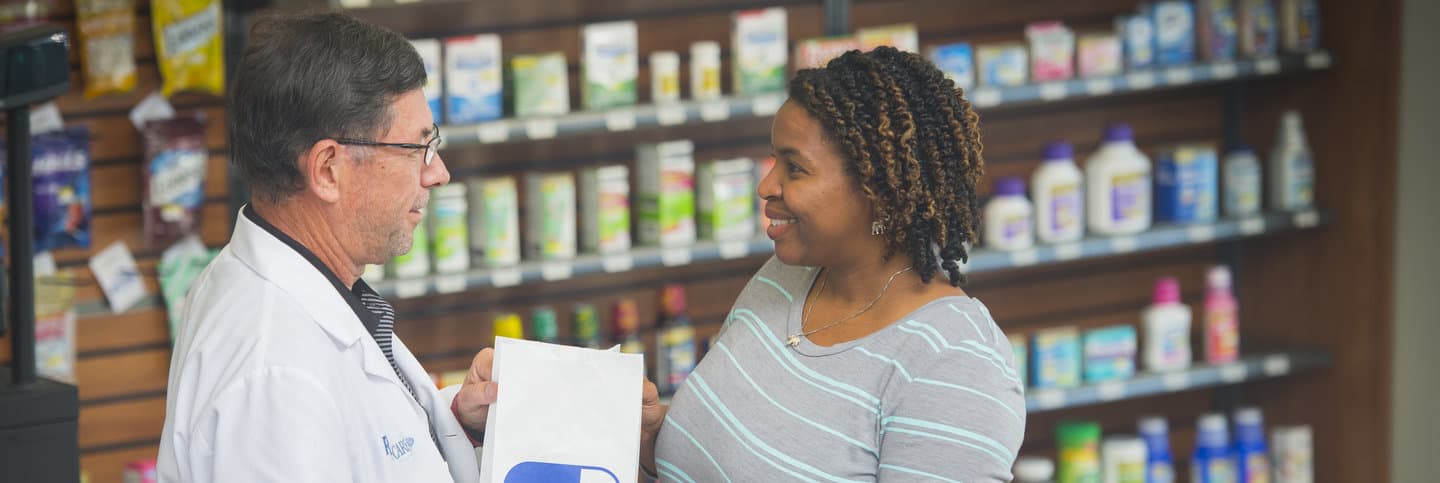 A pharmacist talks with a customer.