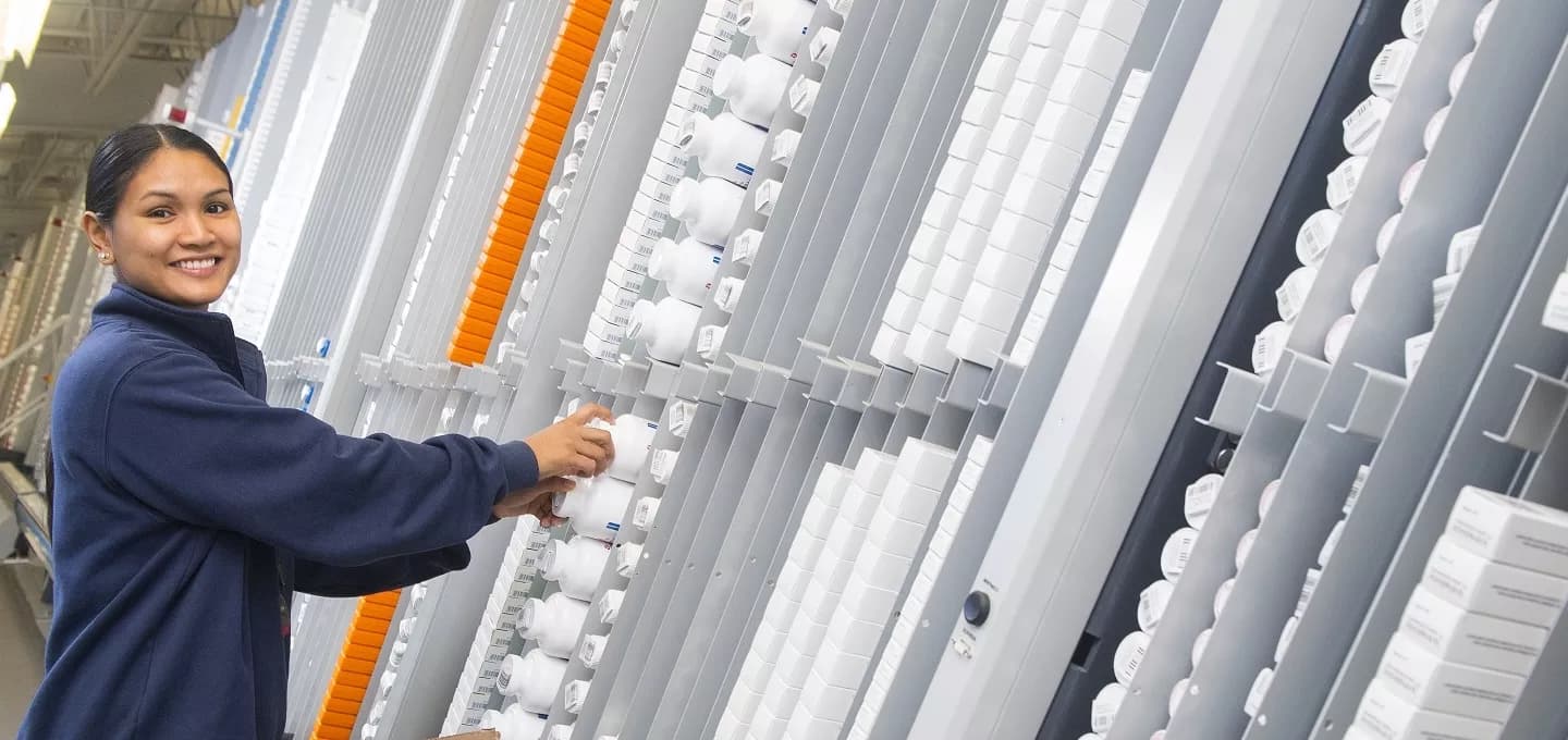 A worker stocking the a-frame with product.